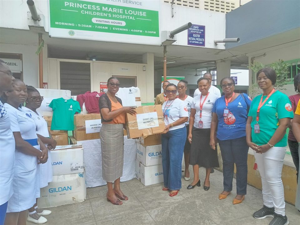 NBS and hospital representatives hand over a box of donated T-shirts at Princess Marie Louise Children’s Hospital.