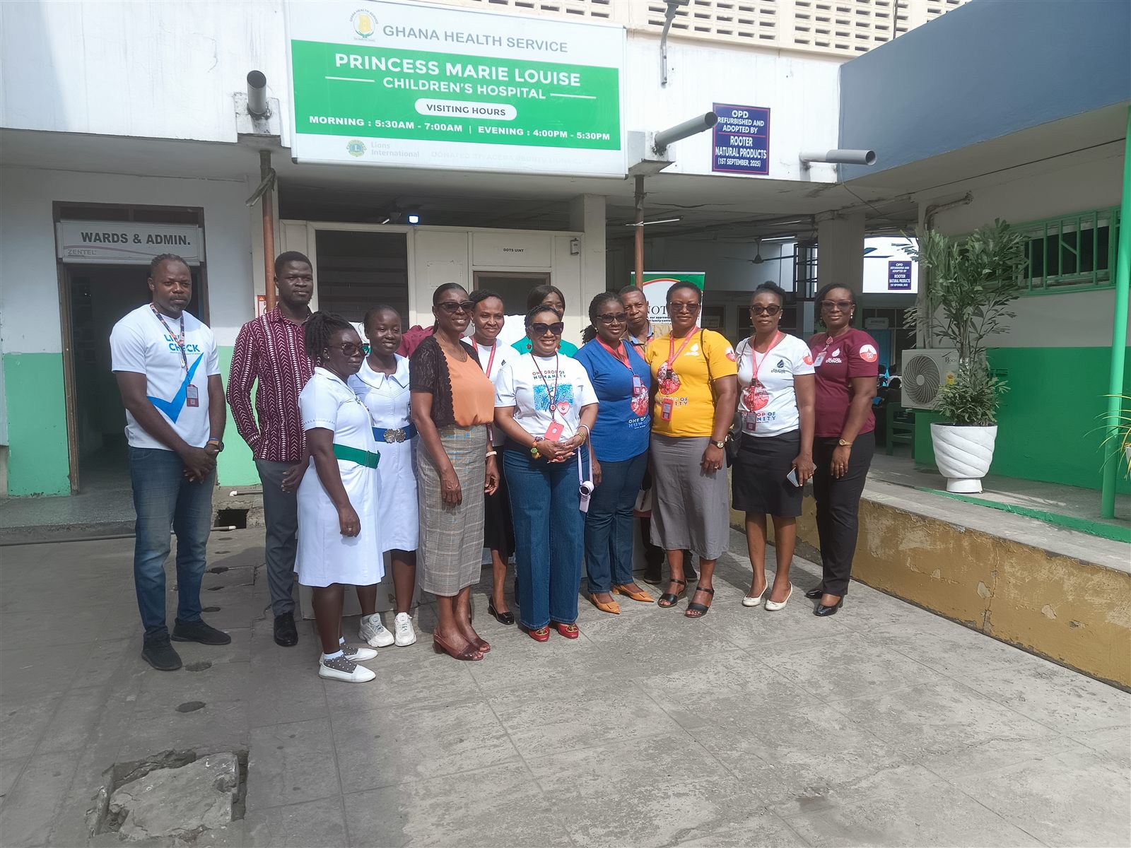 NBS and Princess Marie Louise Children’s Hospital representatives pose beneath the hospital sign after the donation.